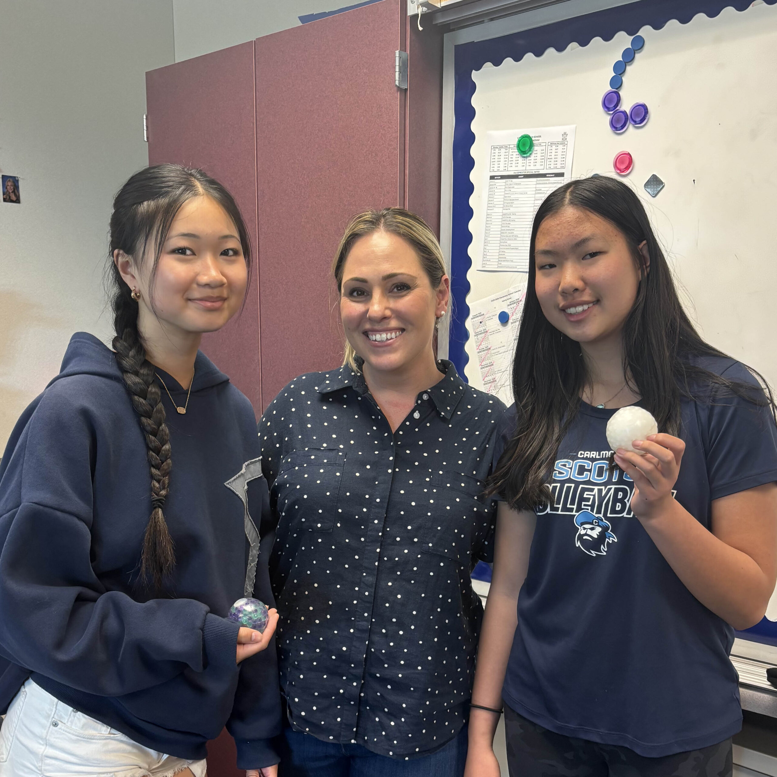 Two AS English students standing next to their teacher