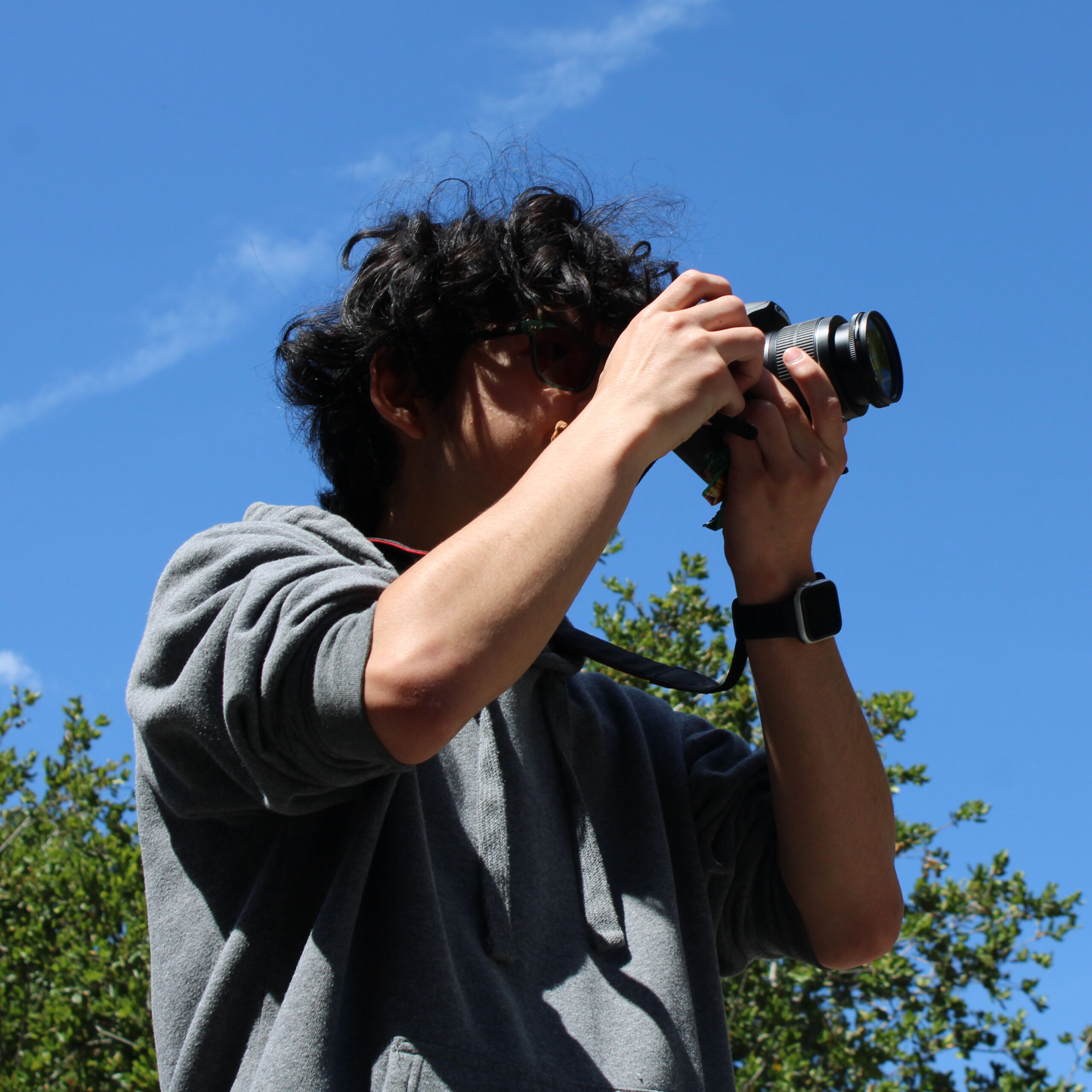 Student outside using camera