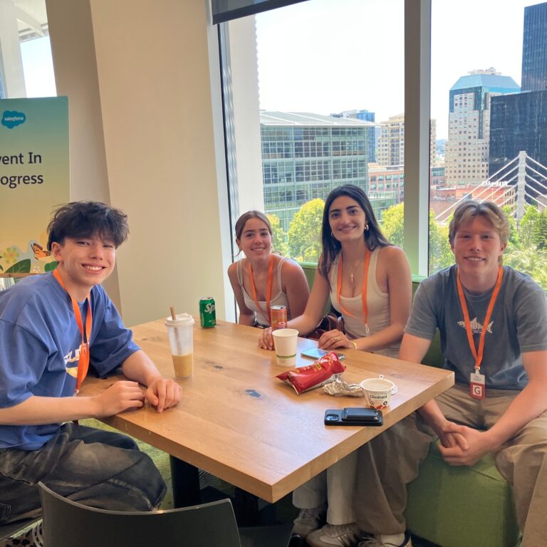 Four students at a conference table in SF